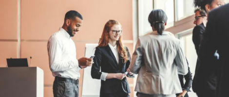 a stock image of three people in business wear networking and having a conversation