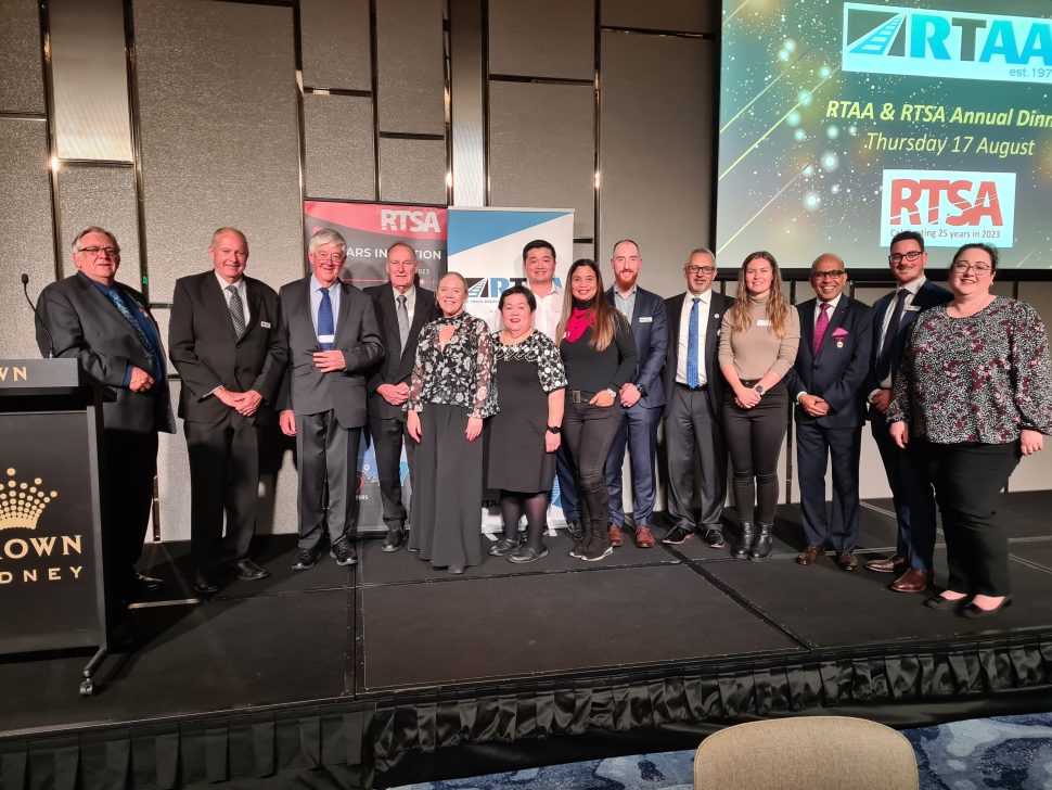 Image of the RTSA NSW Chapter past and present members standing on stage at the RTSA/RTAA Annual Dinner 2023 in Sydney