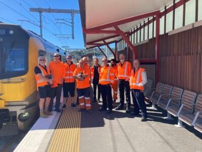image of the PACE project team in high visibility clothing standing on a platform next to a train